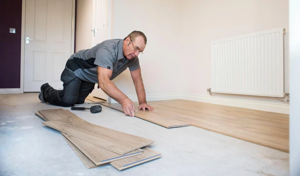 Indoor flooring being installed by company owner